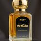 Perfume bottle labeled 'Oud Al Zahra' by Decoy on a dark background