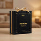 Black perfume box with gold ribbon and text on a blurred background