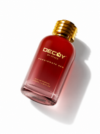 DECAY BY FFACE Passionate Red Eau de Parfum bottle, featuring a translucent deep red glass bottle with a metallic gold screw cap, shown on a clean white background with a soft shadow.