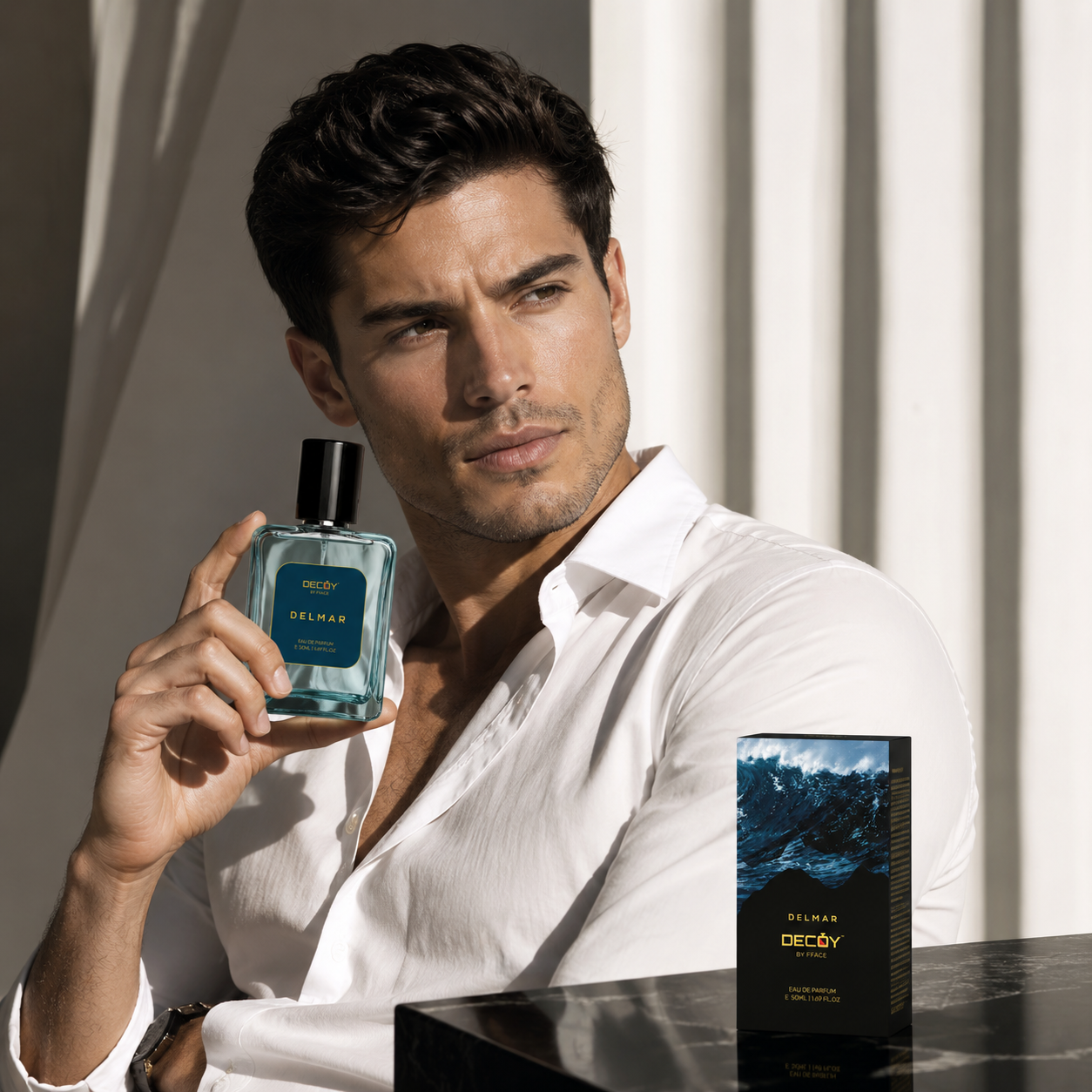 Man holding a Declyn perfume bottle with a white shirt and a neutral background
