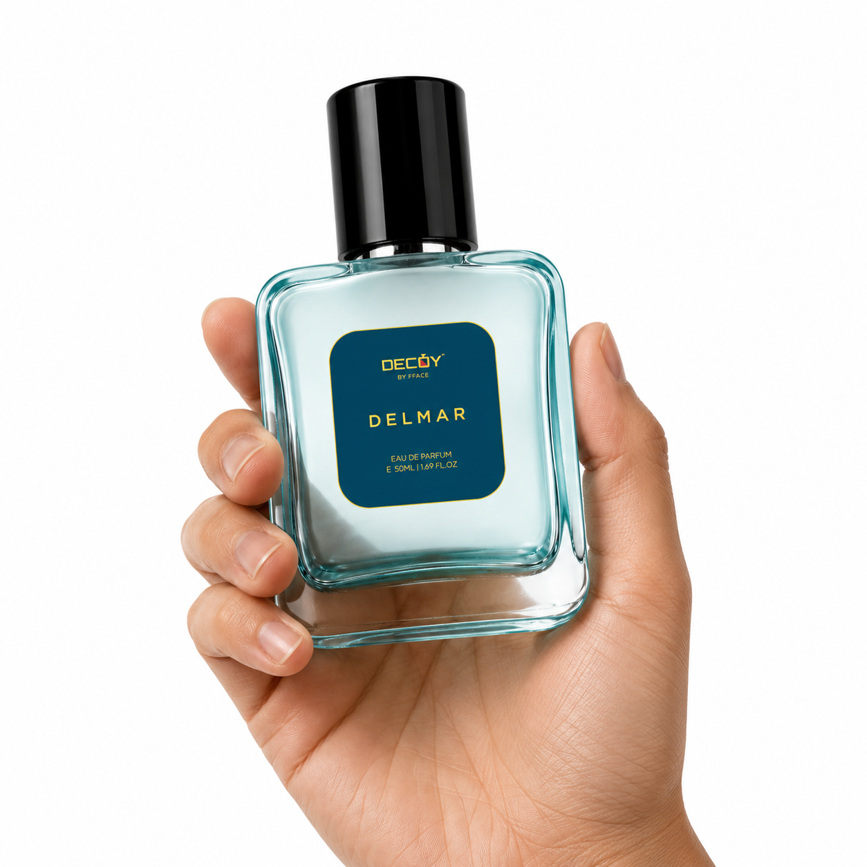 Hand holding a blue perfume bottle labeled 'Delmar' on a white background