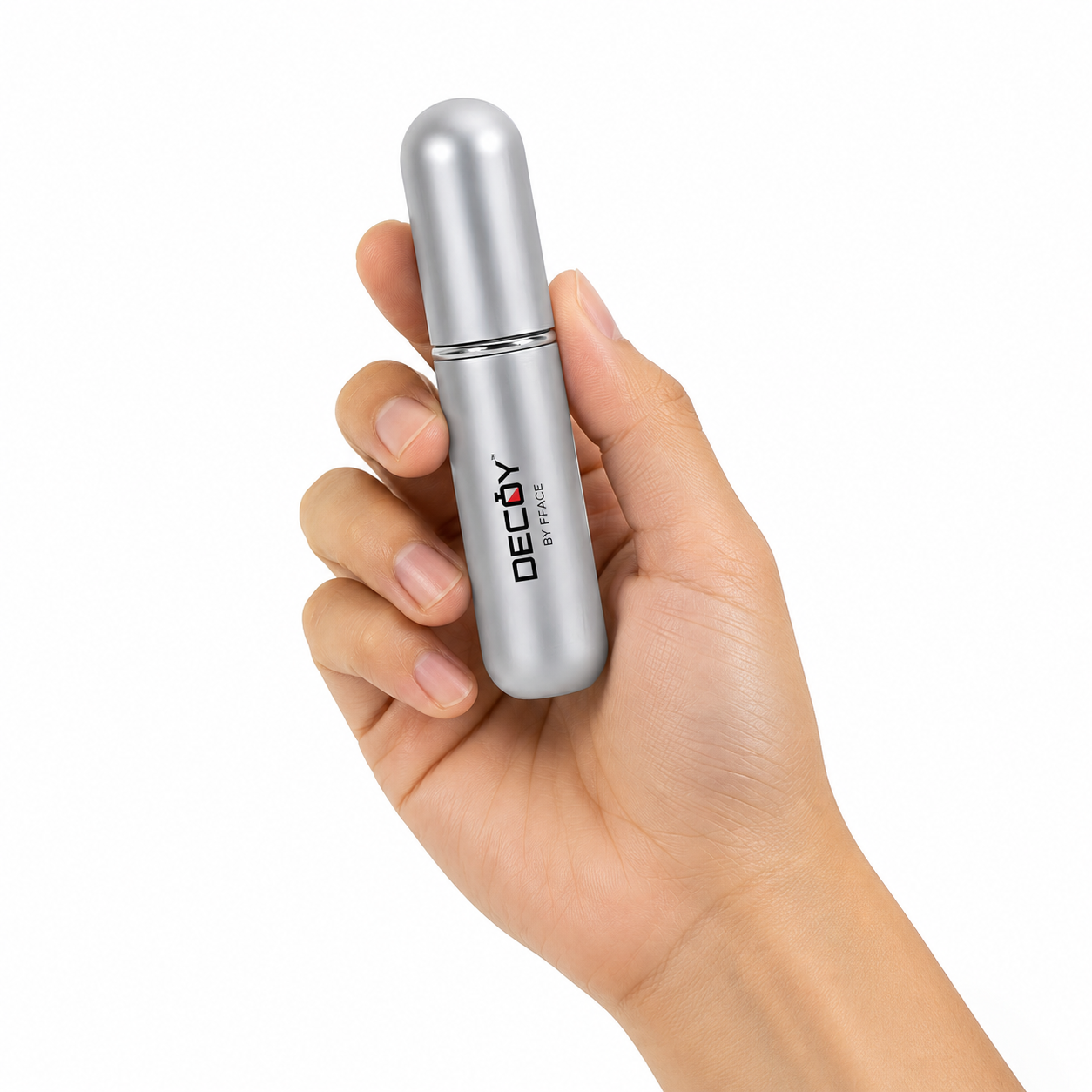 Hand holding a silver cylindrical product with 'DECOY' branding on a white background