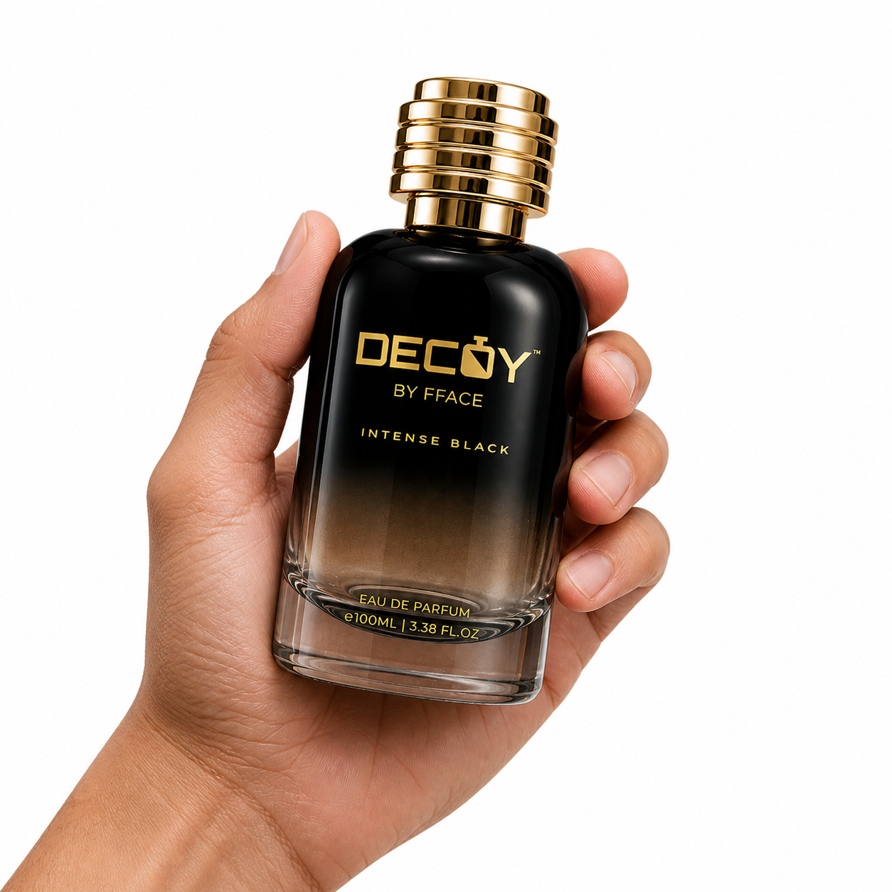 Hand holding a black and gold Decoy by Fface perfume bottle on a white background