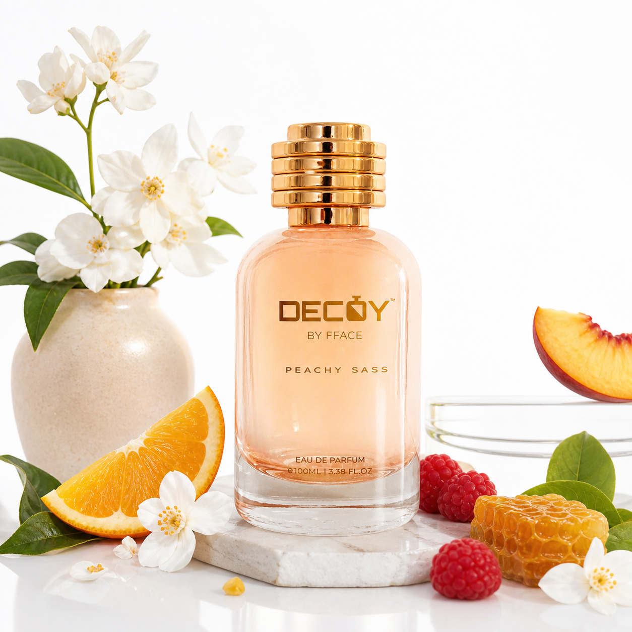 Decoy by Fface perfume bottle with peach slices, flowers, and berries on a white background