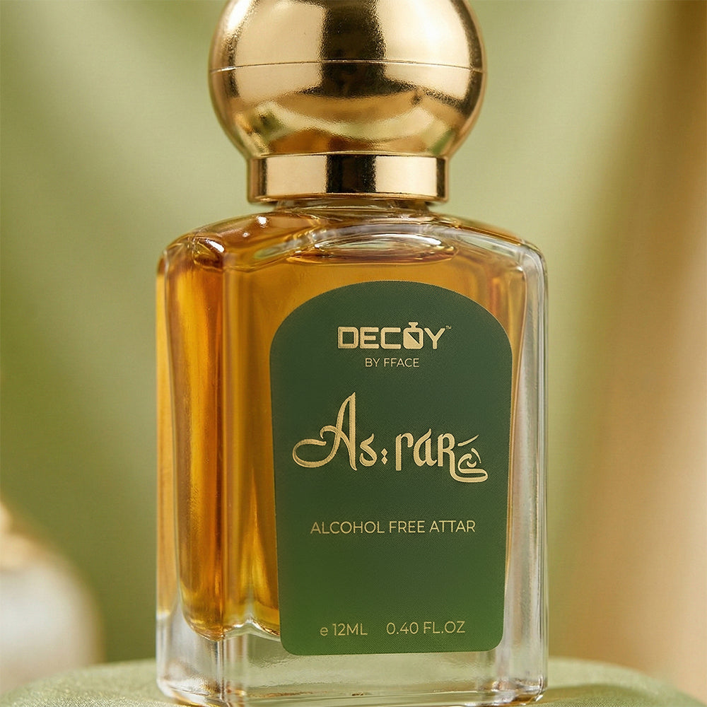 Decoy by Fface alcohol-free attar bottle with gold cap on a blurred background