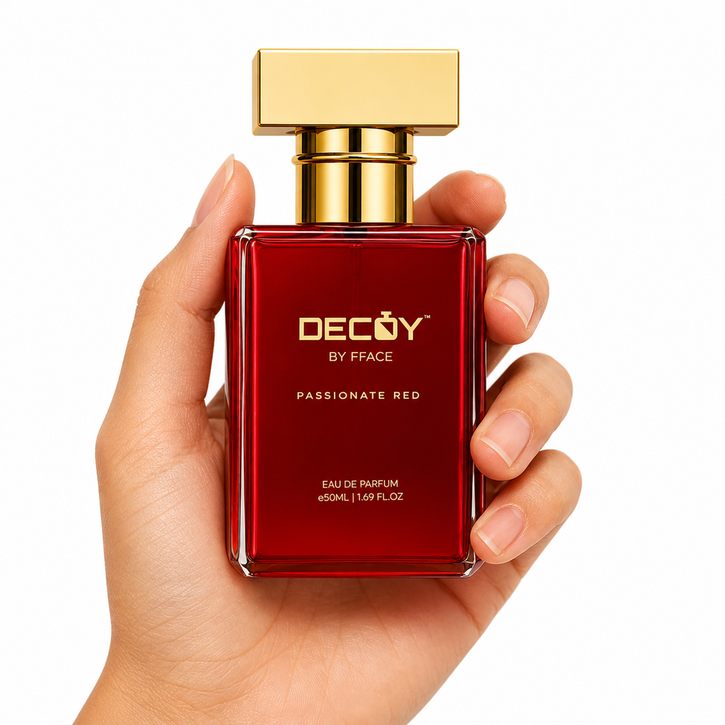 Hand holding a red perfume bottle with gold cap labeled 'DECOY by FFACE Passionate Red' on a white background