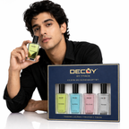 Man holding a Decoy by Fface perfume bottle with a gift set in the foreground