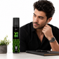Man sitting at a desk with a bottle of 'Vibe' deodorant next to him
